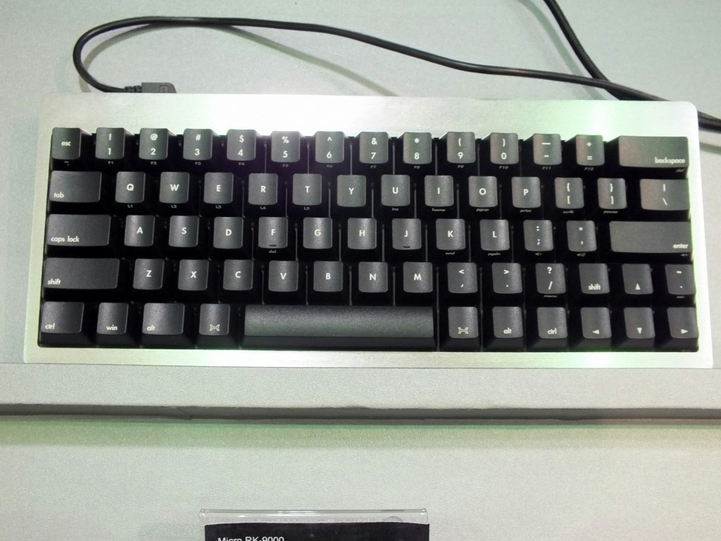 高剛性なアルミ製筺体に身を包むメカニカルキーボード。66キー英語配列のコンパクト設計で、スペースキー両脇にファンクションキーを配置する